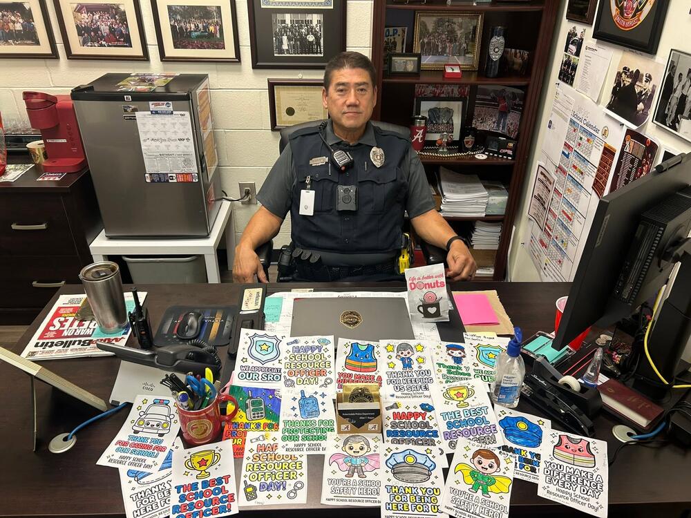 Officer with student artwork